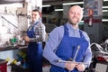 Mechanics in a bike repair station Royalty Free Stock Photo