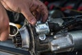 Mechanics with dirty hands repair broken starter on car/ Automotive service Royalty Free Stock Photo