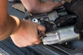 Mechanics with dirty hands repair broken starter on car/ Automotive service