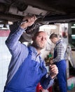 Mechanics fixing car Royalty Free Stock Photo