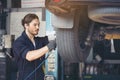 Mechanics Fixing Car Tires At Garage Royalty Free Stock Photo