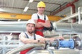 Mechanics repair a machine in a modern industrial plant - profession and teamwork - portrait group workman