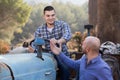 Mechanics reparing old agrimotors at farm