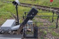 Crossing barrier deviceto raise barrier on road when train passes. Box with control electronics, motion sensor, large metal lever