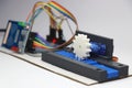 Mechatronics project demonstration with 3d printed gear and slider mechanism and micro controller on the background isolated on Royalty Free Stock Photo