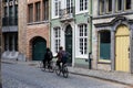 Mechelen, Antwerp Province, Belgium - Teenagers driving the bicycle in the cobble stone streets of old town