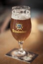 Glass of Troubadour Belgian beer