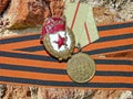 The medal `For the Defense of Stalingrad` and a sign of `Guards` on the background of the St. George`s ribbon. Heirloom. Memory.