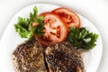 Medallion on a plate with slices of tomato Royalty Free Stock Photo