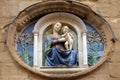Medallion with the Virgin Mary and Child by Luca della Robbia on the facade of Orsanmichele Church in Florence, Italy Royalty Free Stock Photo
