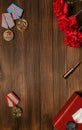 Medals and flowers on wooden table for day of glory, 9 may.