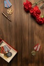 Medals and flowers on wooden table for day of glory, 9 may.