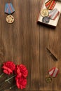 Medals and flowers on wooden table for day of glory, 9 may.