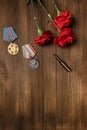 Medals and flowers on wooden table for day of glory, 9 may.