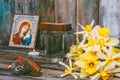 Medals, Orthodox icon and a burning candle, a bouquet of Narcissus flowers