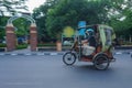 Medan, North Sumatera - July 23, 2021: a rickshaw driver is delivering ordered goods