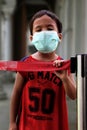 Medan, North Sumatra, Indonesia - February 2020: A small child wears a green mask for safety because of the current epidemic of th