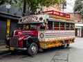 A colorful designed old-timer bus vintage for tourist tours parked on the side of the road Royalty Free Stock Photo