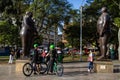 Tourist on a bike tour at the Fernando Botero square in the center of the city of Medellin. Adan and Eva sculpture Royalty Free Stock Photo