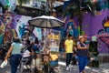 MEDELLIN, COLOMBIA - JANUARY 17, 2024: Tropical fruits sale and tourists at the famous Comuna 13 in Medellin on a beautiful sunny