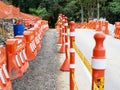 Medellin, Colombia, October 20 2019: orange construction barriers on a road works with pedestrian path Royalty Free Stock Photo