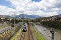 Medellin metro station with railway tracks and people, Colombia