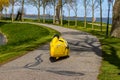 Medemblik, Noord-Holland, Netherlands. April 14, 2021. Rear view of a yellow Velomobile bicycle riding on a path Royalty Free Stock Photo