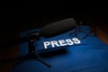 Media Journalism Global Daily News Content Concept. Blue journalist (press) vest in dark with backlight and fog. Media microphone Royalty Free Stock Photo