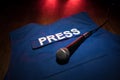 Media Journalism Global Daily News Content Concept. Blue journalist (press) vest in dark with backlight and fog. Royalty Free Stock Photo