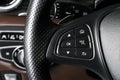 Media and navigation control buttons on a steering wheel of a Modern car. Car interior details. Brown leather interior of the luxu Royalty Free Stock Photo