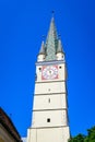 Medias, Romania, 14 July 2021: Old stone clock tower at the Saint Margaret evangelical church Biserica Evanghelica Sfanta