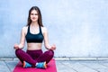 Mediatation. Girl in sport wear relax in yoga asana - blue wall, copy space Royalty Free Stock Photo