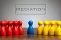 Mediation concept with pawn figurines on table