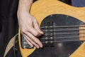 Mediator technique of playing with the right hand on a five string electric bass guitar Royalty Free Stock Photo
