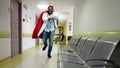 Medic acts like a superhero in hospital to fight pandemic of covid19 coronaviruses. Blue background