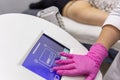 A medic adjusts the operating mode of the anti-cellulite massage machine with compression and vibration technology in beautician