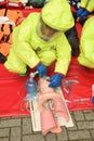 Medic in breathing apparatus and CBRN suit practices resuscitation. Royalty Free Stock Photo