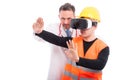 Medic helping constructor holding hands with virtual reality glasses