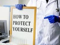 Medic holds sign How to Protect Yourself. Coronavirus COVID-19