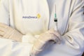 Medic ,scientist, pharmacist holding Syringe with AstraZeneca logo on lab coat. Coronavirus, Covid-19 vaccine concept Royalty Free Stock Photo