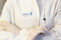 Medic ,scientist, pharmacist holding Syringe with Janssen logo on lab coat. Coronavirus, Covid-19 vaccine concept
