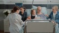 Medic showing x ray results to woman in hospital ward