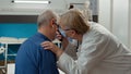 Medic using otoscope instrument to do ear examination