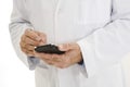 Caucasian doctor wearing a white lab coat using PDA Royalty Free Stock Photo