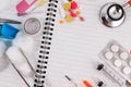 Medical accessories with blank notebook on the wooden table. Royalty Free Stock Photo