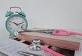 Medical and alarm clock stethoscope and notebook Royalty Free Stock Photo