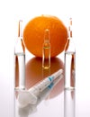 Medical ampoules with orange and syringe on a white background. Natural remedies. Natural cosmetology Royalty Free Stock Photo