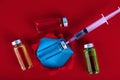 Medical ampoules and syringe on a red background. Copy space. Selective focus Royalty Free Stock Photo