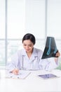 Medical asian doctor working with hologram interface at hospital Royalty Free Stock Photo