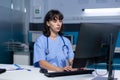 Medical assistant using keyboard and computer at office